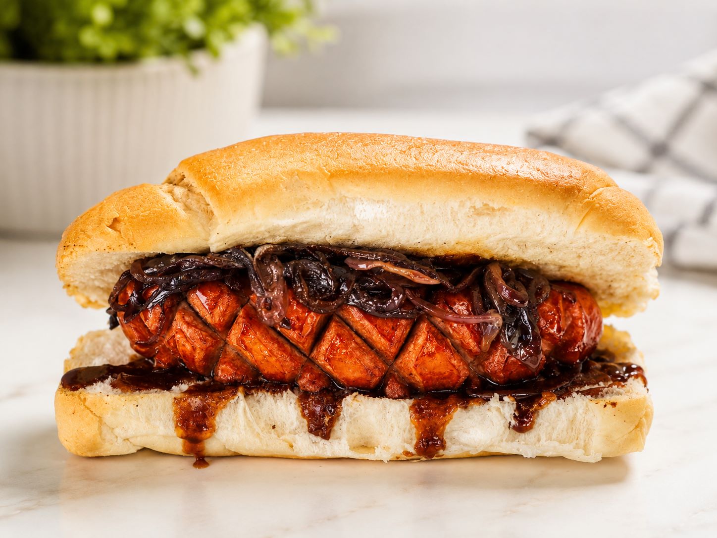 Kransky and onion on a roll